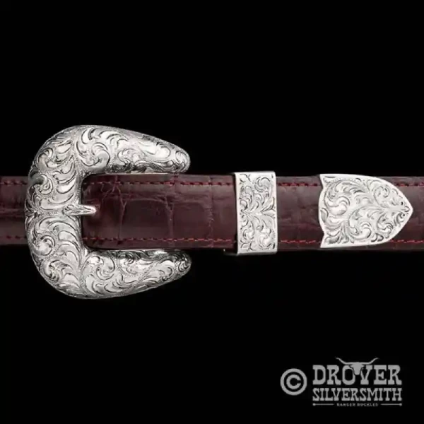 The Lasso Sterling Silver Buckle feautures a fine engraving combination of hand engraved scrollwork that makes for a sophisticated dual tone Western Look. Add a second loop for a ranger buckle set now!
